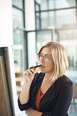Buy stock photo Business woman working, thinking and brainstorming alone on a white board for a meeting. Office employee working on creative marketing presentation. Modern female worker planning for a job project