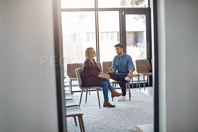 Buy stock photo Business man in a job interview with a businesswoman talking about hiring and recruitment. An HR manager and employee sitting and having a discussion or meeting in a modern office or workplace