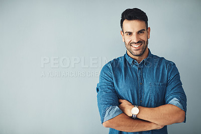 Buy stock photo Studio portrait of a handsome young man posing against a gray background