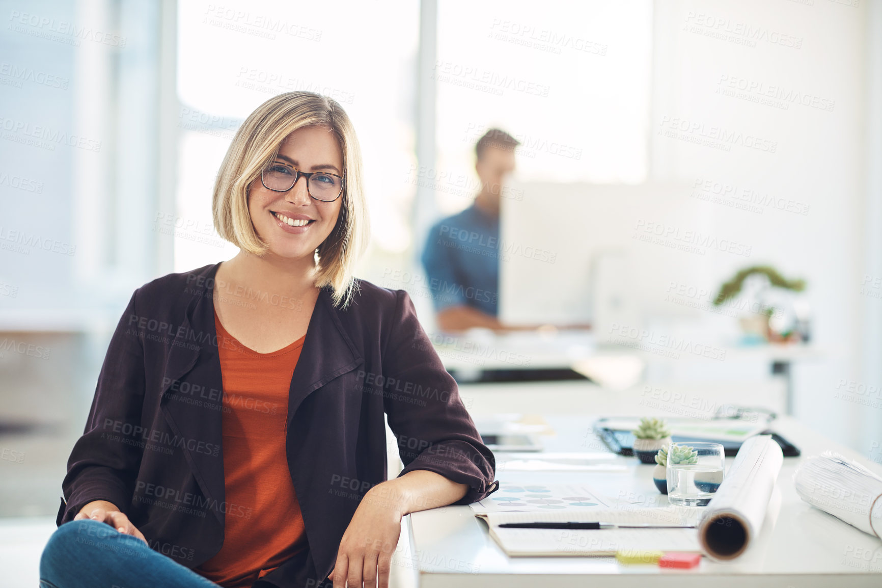 Buy stock photo Portrait of a young woman working at her desk in a modern office