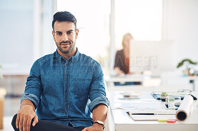 Buy stock photo Portrait of a young, trendy and fashionable designer sitting at his office desk. Male creative taking a break at work, next to drawing desk. Expert contemplating ideas for new architectural designs