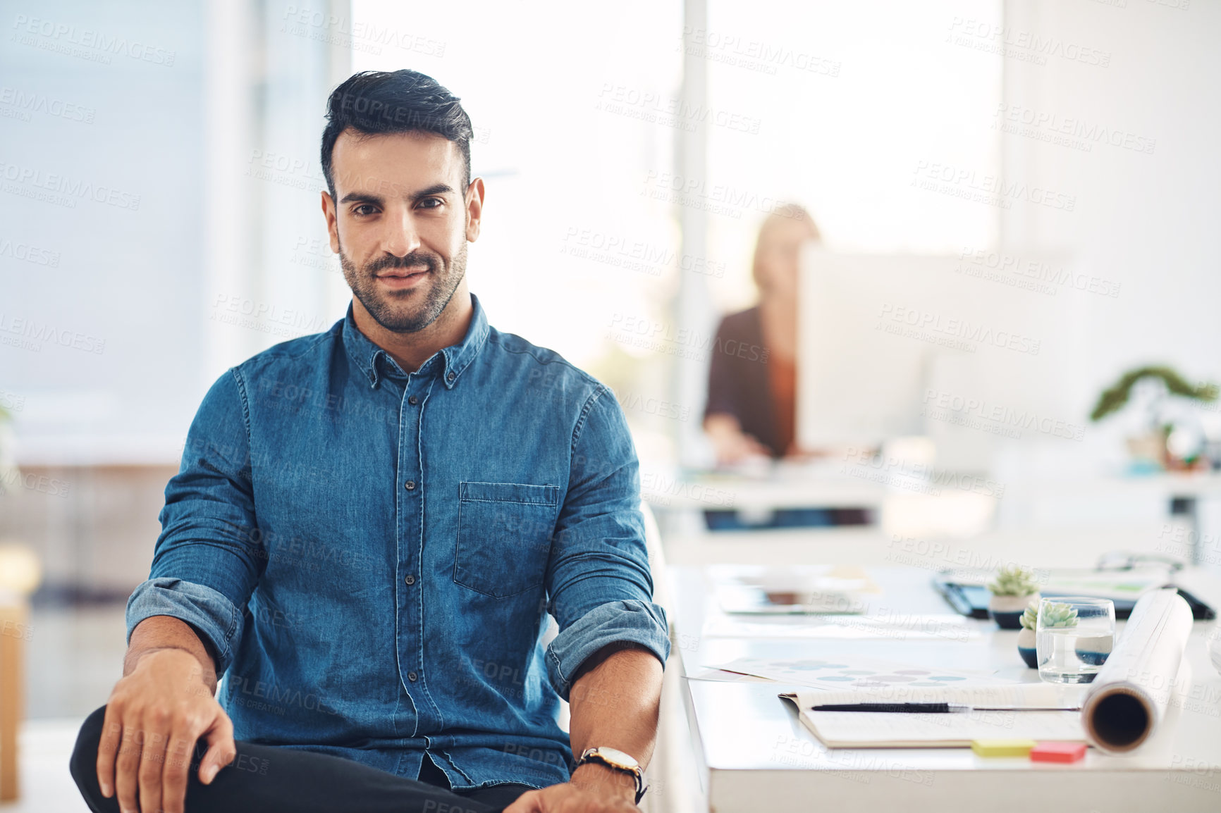 Buy stock photo Portrait of a young, trendy and fashionable designer sitting at his office desk. Male creative taking a break at work, next to drawing desk. Expert contemplating ideas for new architectural designs