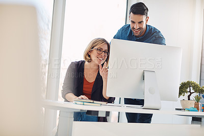 Buy stock photo Teamwork and unity of two colleagues and coworkers working together on a computer in the office. Business man and woman talking, discussing and planning in a meeting for brainstorming ideas at work