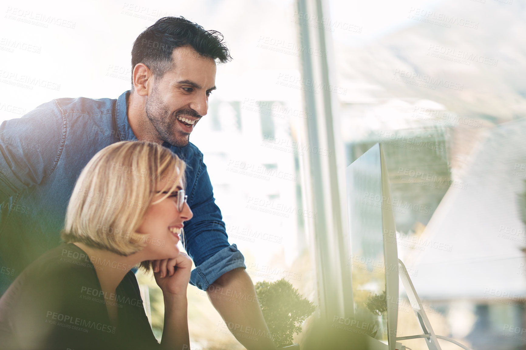 Buy stock photo Teamwork and unity of two colleagues and coworkers working together on a computer in the office. Businessman and woman talking, discussing and planning in a meeting for brainstorming ideas at work 