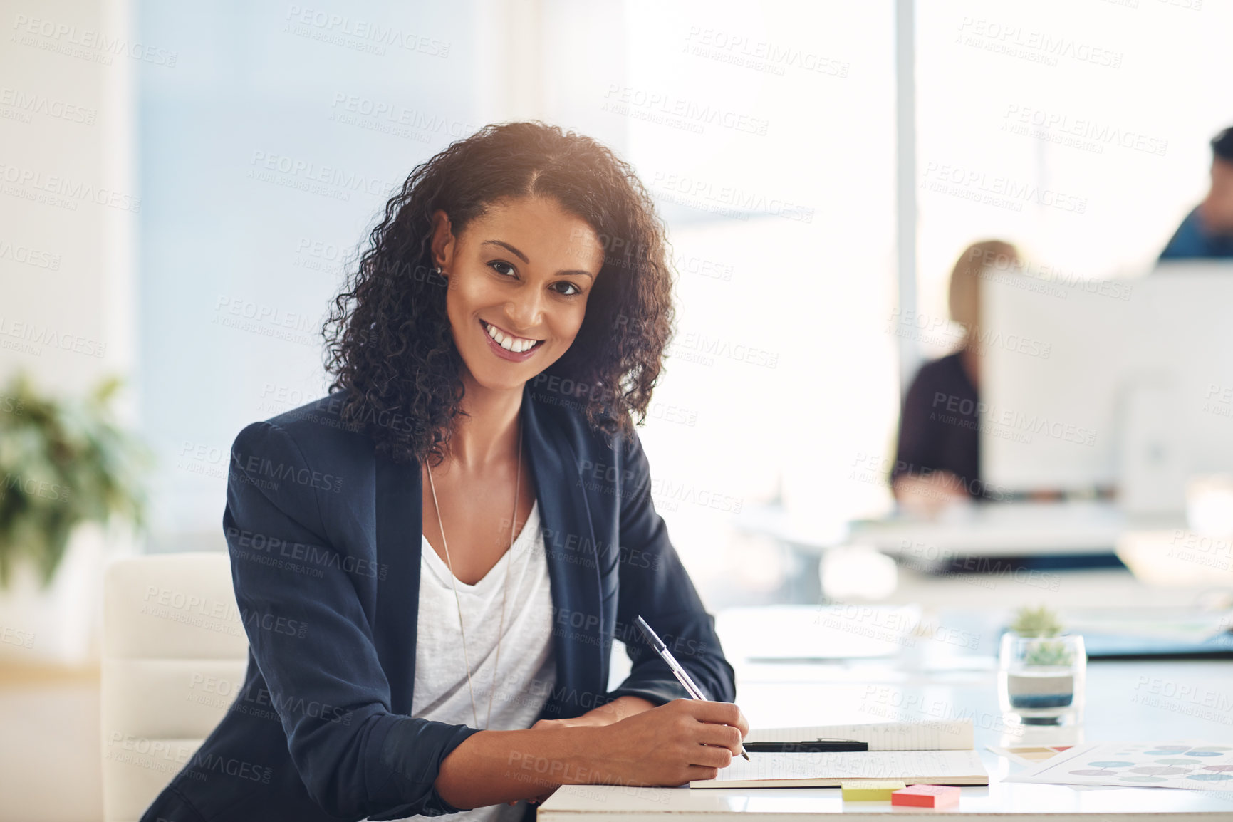Buy stock photo Confident and smiling portrait of a businesswoman, marketing executive or corporate worker working, writing and planning schedule in notebook at an office. Face of a happy administrator brainstorming