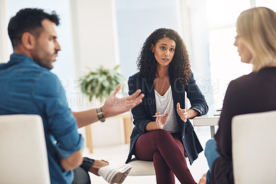 Buy stock photo Couple fighting and arguing in therapy session with patient therapist helping inside office. Female marriage counsellor working, explaining and talking to angry, frustrated and hurt married people