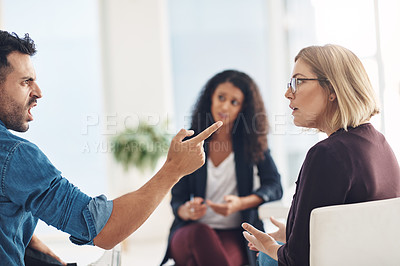 Buy stock photo Angry couple talking, arguing and fighting during marriage counseling in professional therapist office. Husband and wife with bad communication problem in therapy, shouting and yelling 