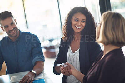 Buy stock photo Handshake by businesswomen to congratulate in a meeting at work. Business professionals greet and make deals to collaborate in a corporate office. Mature female boss giving an employee a promotion