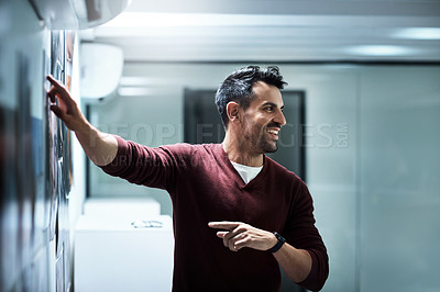 Buy stock photo Shot of a businessman presenting his ideas during a brainstorming session at work