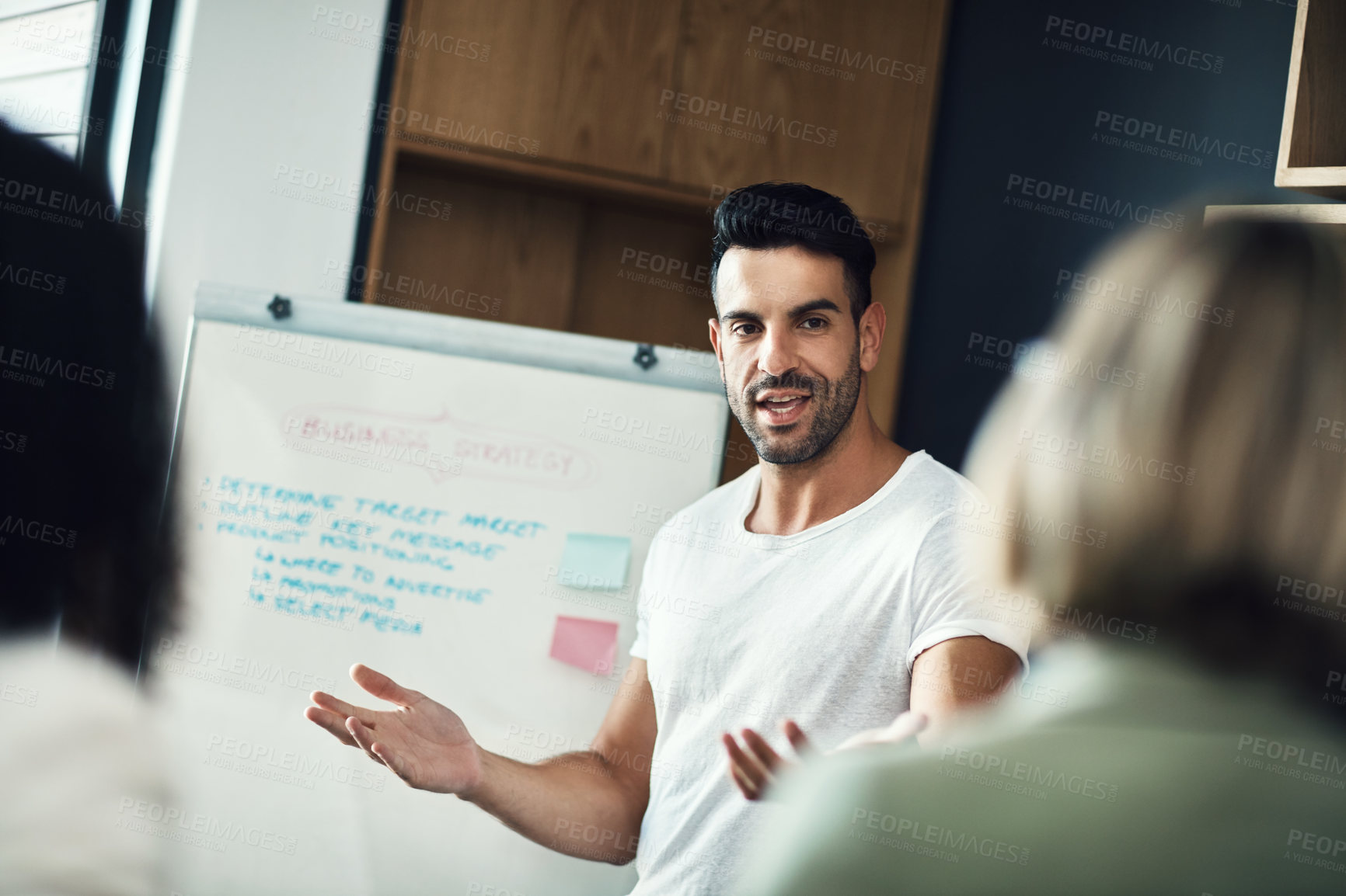 Buy stock photo Presentation meeting, whiteboard and man explain strategy, business plan or brainstorming ideas, coaching or teaching team. Group mentor, coach or startup leader speaking to creative design staff