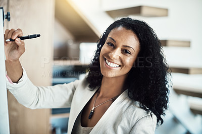 Buy stock photo Portrait of a young businesswoman writing notes on a white board during a brainstorming session at work