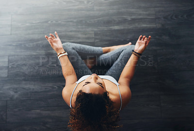 Buy stock photo High angle shot of a young woman practising yoga