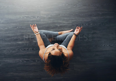 Buy stock photo High angle shot of a young woman practising yoga