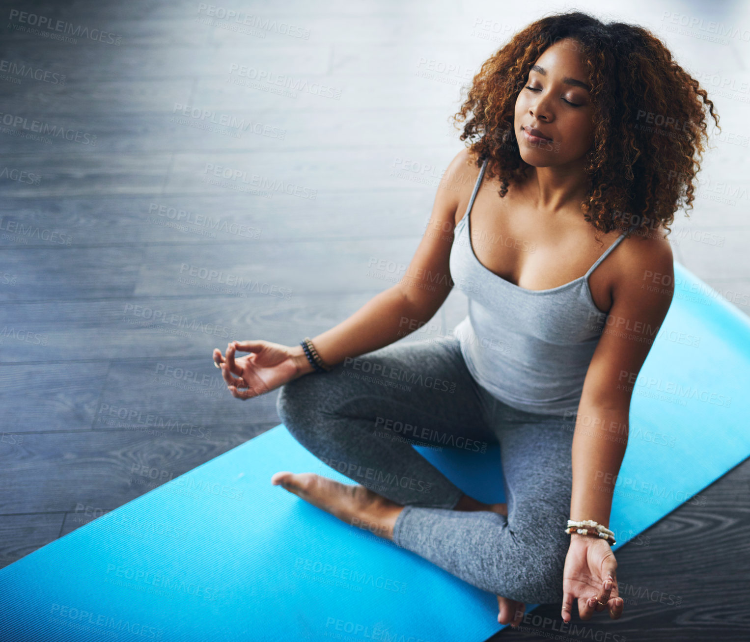 Buy stock photo African woman, mindfulness and yoga in lotus pose for peace, balance or wellness in zen or relax. Female person, breathing and energy for calm, meditation or health in pilates studio with eyes closed