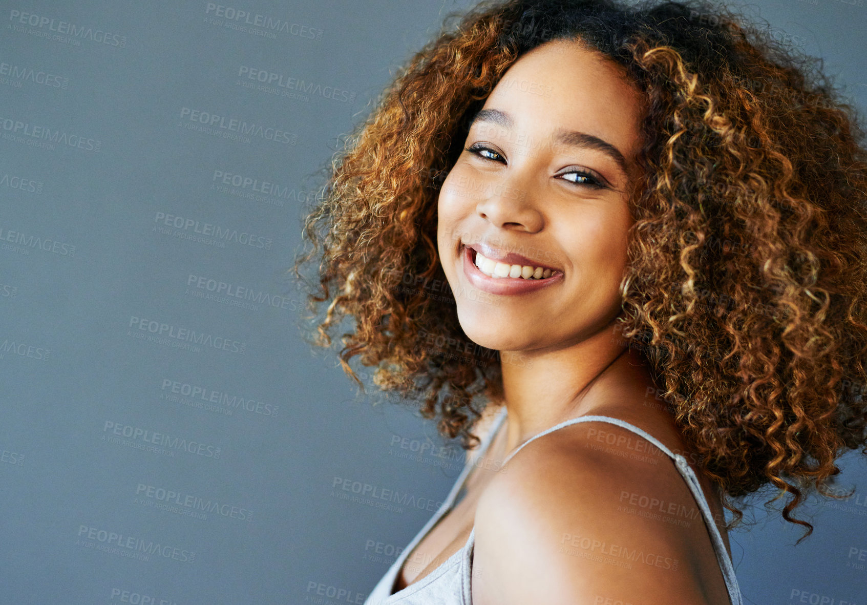 Buy stock photo Hair care, black woman and space for beauty, portrait or natural cosmetics for wellness. Gray background mockup, healthy shine or happy model in studio with smile, texture or confidence in Brazil