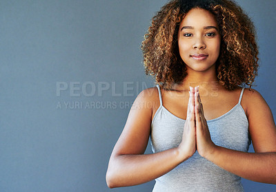 Buy stock photo Cropped shot of a young woman practising yoga by herself