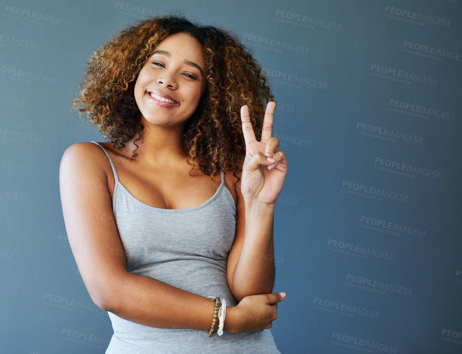 Buy stock photo Girl, happy and peace sign with studio portrait, emoji and mockup space for vote by background. Woman, person and model with smile for pride with v icon, symbol or excited with confidence in Colombia