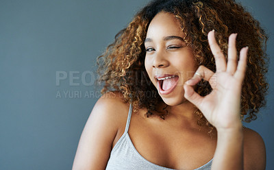 Buy stock photo Studio shot of an attractive young woman against a grey background