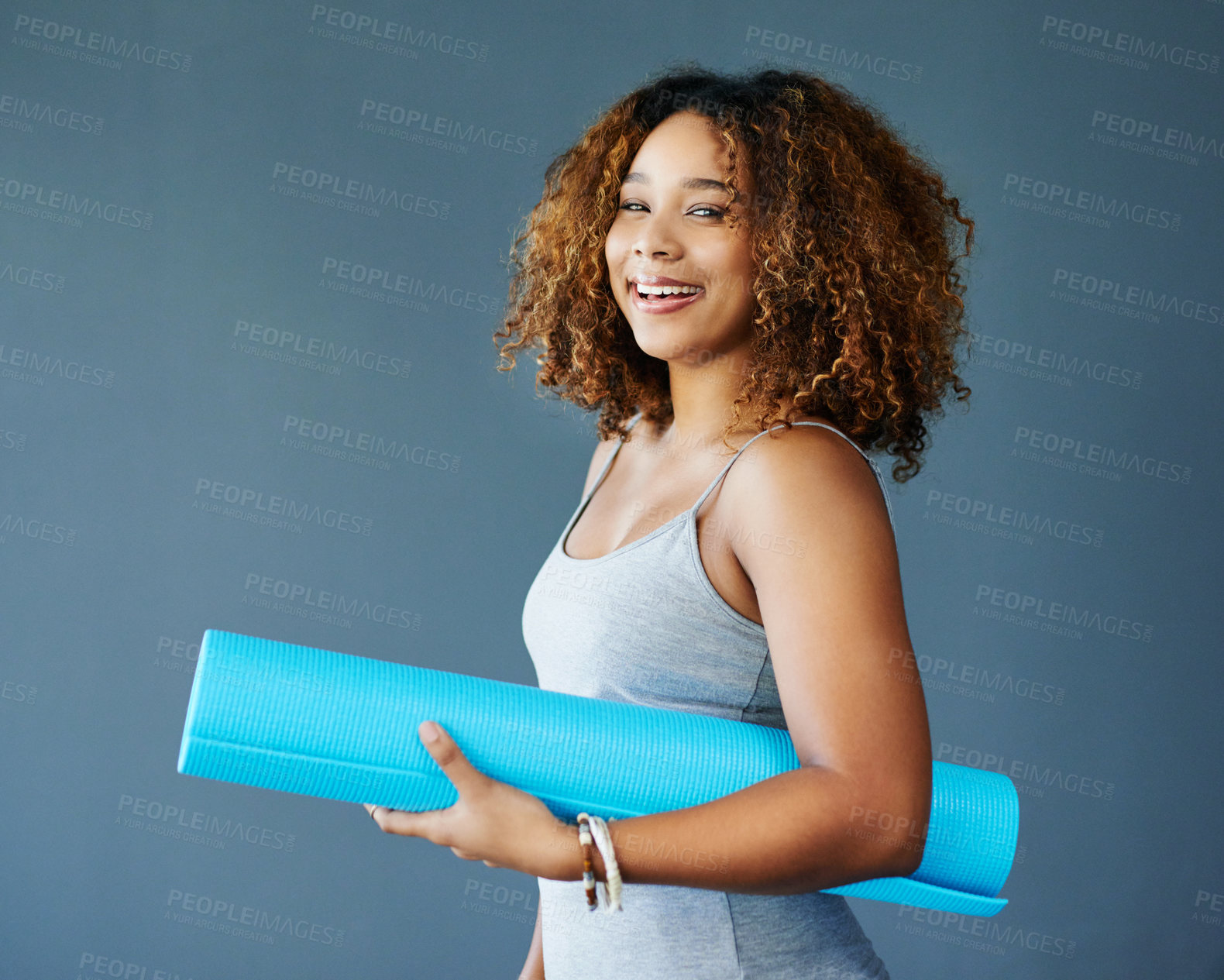 Buy stock photo Yoga, happy and portrait of woman with mat in studio for wellness, health and zen energy. Smile, meditation and person with equipment for exercise, pilates and active workout on blue background