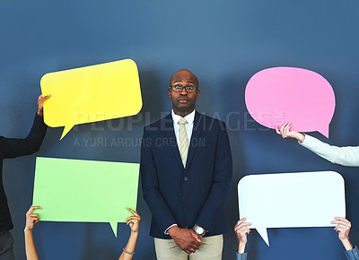 Buy stock photo Cropped shot of people holding up speech bubble around a young man