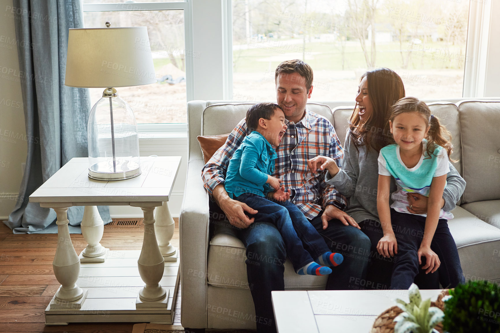 Buy stock photo Smile, family and relax with love on sofa for weekend break, affection and interaction with children for care. Mother, father and kids on couch in home for bonding together, comfort and connection.