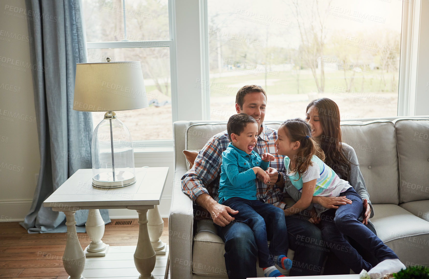 Buy stock photo Happy, family and relax with love on sofa for weekend break, affection and interaction with children for care. Mother, father and kids on couch in home for bonding together, comfort and connection.