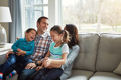 Buy stock photo Funny, kids and happy family in home with parents together for care, love or bonding for support. Children, mother and father on sofa for talking, relax or play with siblings laughing in living room