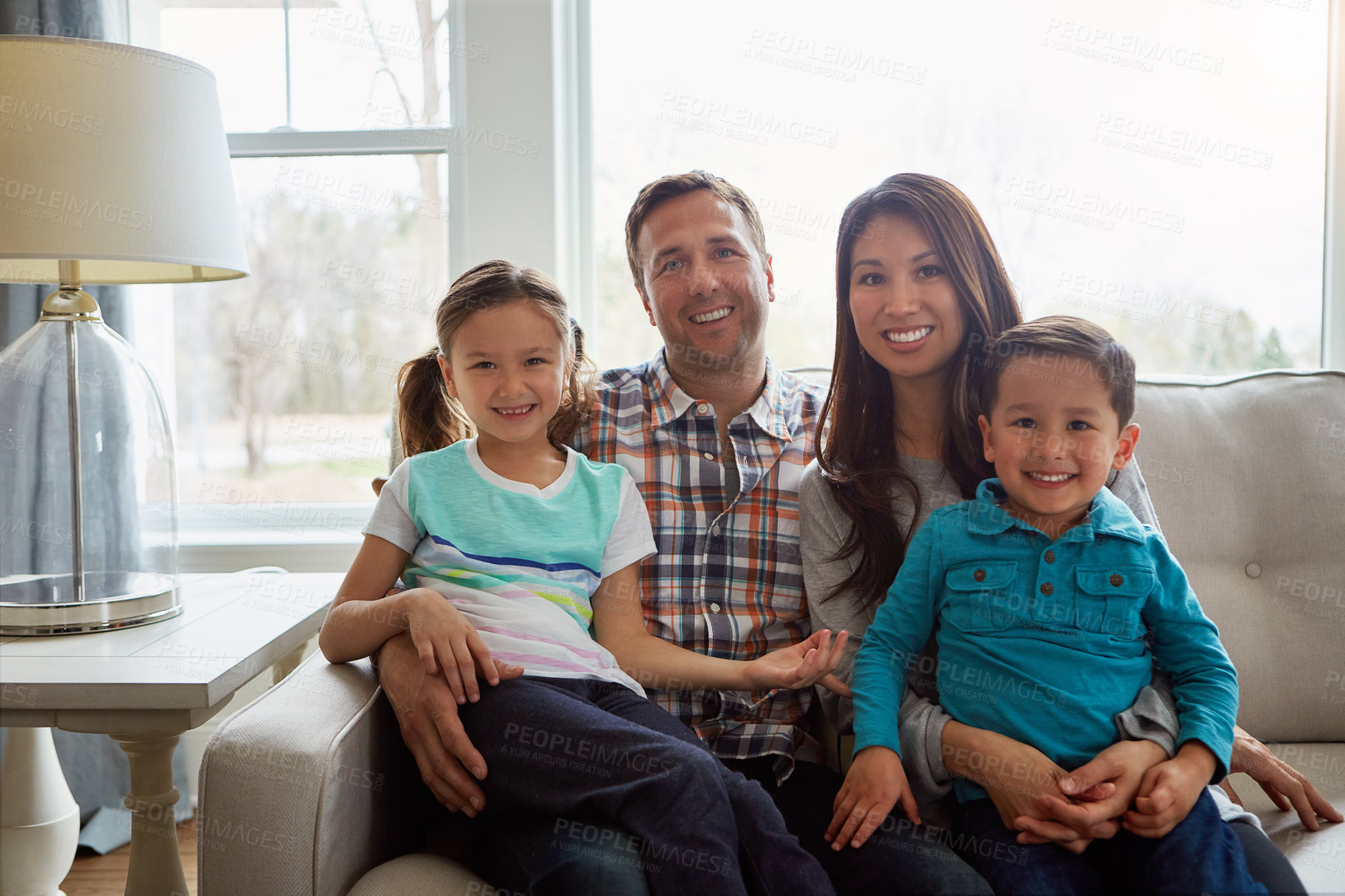 Buy stock photo Portrait, kids and happy family in home with parents together for care, love or bonding. Relax, mother and father with children on sofa for support, connection or relationship with siblings in lounge