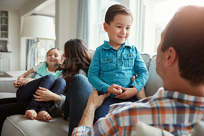 Buy stock photo Shot of a happy young family of four bonding together on the sofa at home