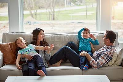 Buy stock photo Relax, children and happy family in house with parents together for care, love or bonding. Kids, mother and father on sofa for support, talking or playing with funny siblings laughing in living room