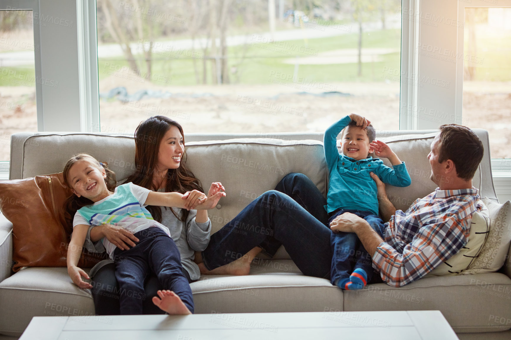 Buy stock photo Relax, children and happy family in house with parents together for care, love or bonding. Kids, mother and father on sofa for support, talking or playing with funny siblings laughing in living room