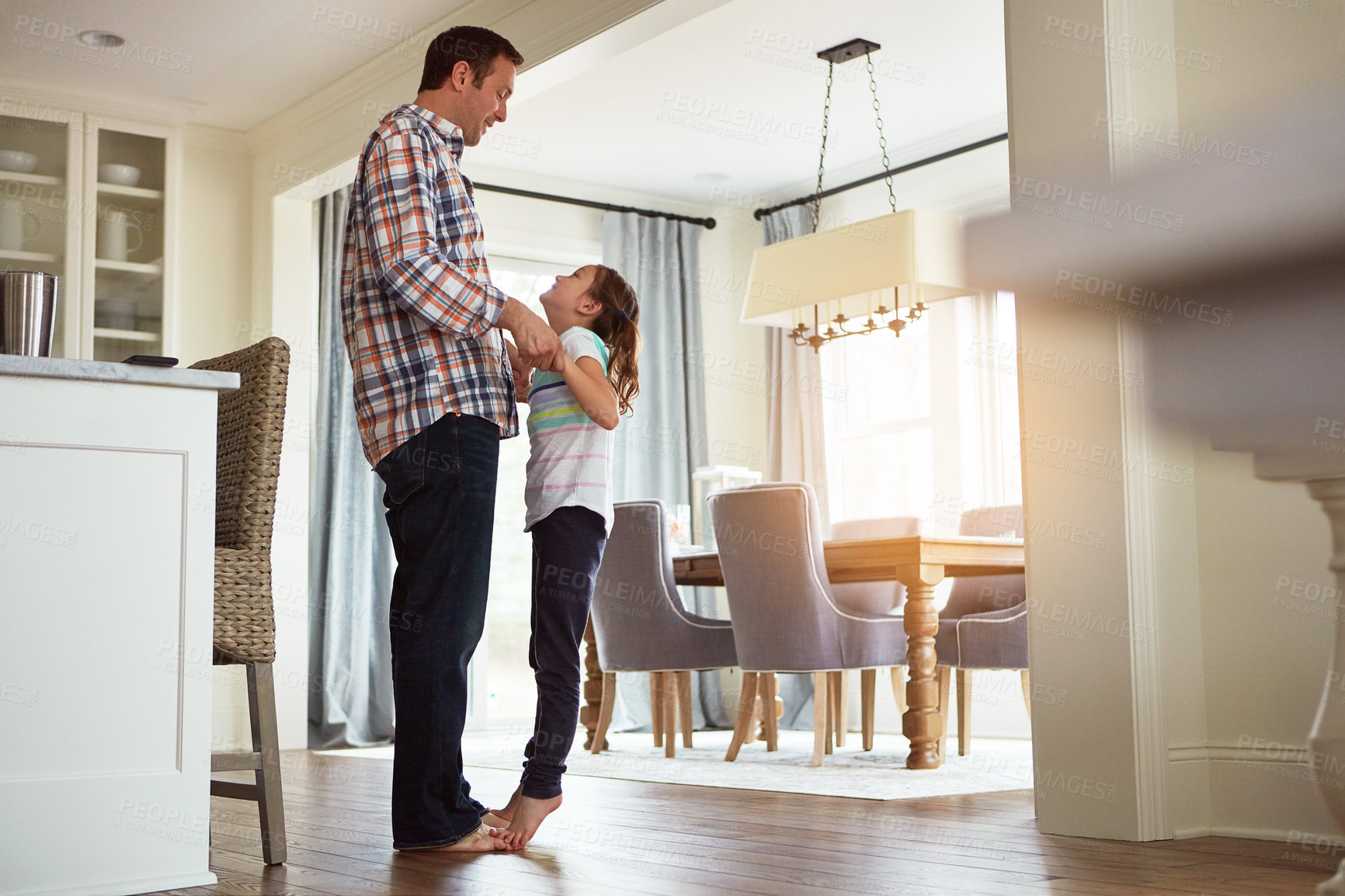 Buy stock photo Father, girl or dancing in living room on feet together, growth or development with role model. Dad, child or playful in house for learning or bonding, superhero parent with princess for fathers day