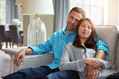 Buy stock photo Shot of a happy young couple relaxing together on the sofa at home