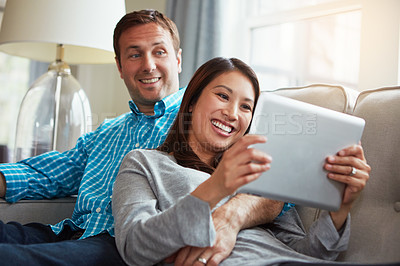 Buy stock photo Relax, tablet and couple on sofa for social media, scroll internet or communication in living room. Lens flare, tech and happy woman with man for entertainment, subscription or watching movie in home