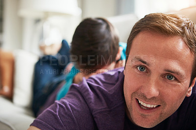 Buy stock photo Shot of an adorable little boy and his father playing together on the sofa at home