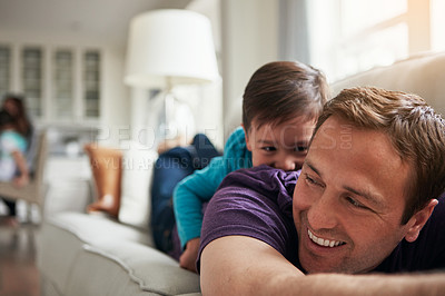 Buy stock photo Playing, laugh and father with child on sofa for bonding, laughing and relax on weekend in home. Family, happy and dad with young boy on couch for playful relationship, love and fun in living room