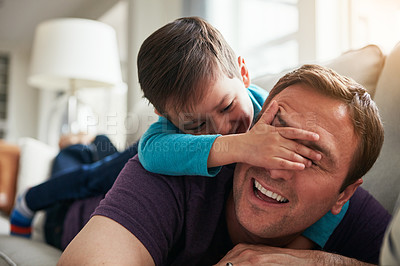 Buy stock photo Playing, peekaboo and father with child on sofa for bonding, laughing and relax on weekend. Family home, happy and dad with young boy cover eyes for playful relationship, love and fun in living room