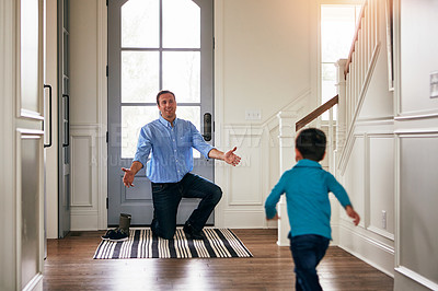 Buy stock photo Shot of a father arriving home to a loving welcome from his son