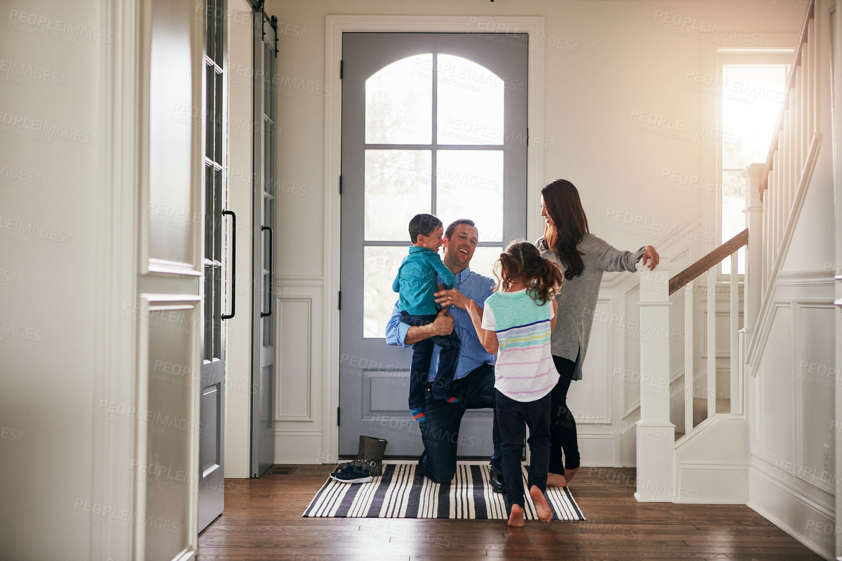 Buy stock photo Hello, door and parents with kids hug in home for greeting, welcome and bonding. Family, happy and mother, father and children in house embrace for affection, relationship and excited for return