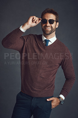 Buy stock photo Studio shot of a stylishly dressed young man posing against a gray background
