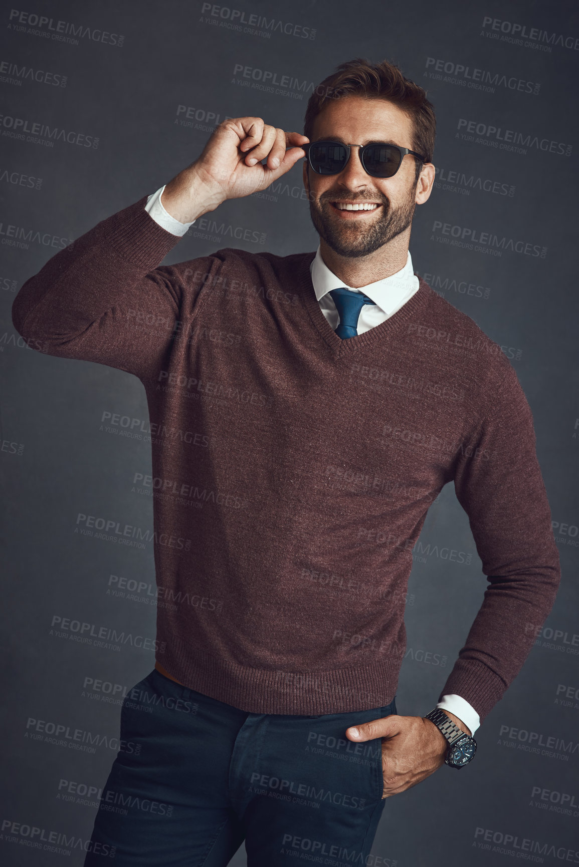 Buy stock photo Studio shot of a stylishly dressed young man posing against a gray background