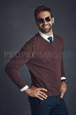 Buy stock photo Studio portrait of a stylishly dressed young man posing against a gray background
