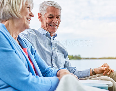 Buy stock photo Shot of a senior couple relaxing on chairs together outside