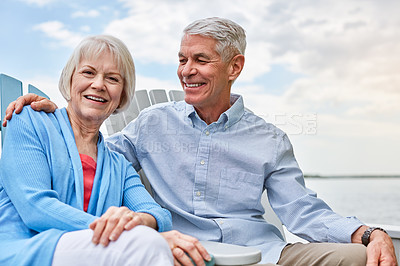 Buy stock photo Portrait of an affectionate senior couple relaxing on chairs together outside