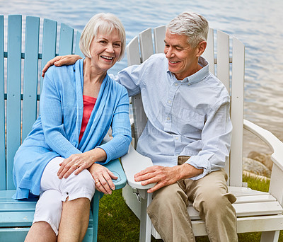 Buy stock photo Portrait of an affectionate senior couple relaxing on chairs together outside