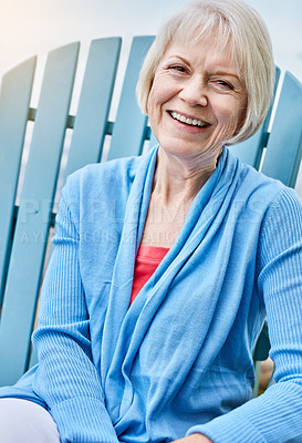 Buy stock photo Portrait of a happy senior woman relaxing on a chair outside