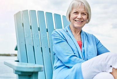 Buy stock photo Portrait of a happy senior woman relaxing on a chair outside