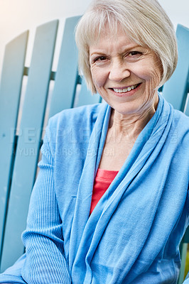 Buy stock photo Portrait of a happy senior woman relaxing on a chair outside