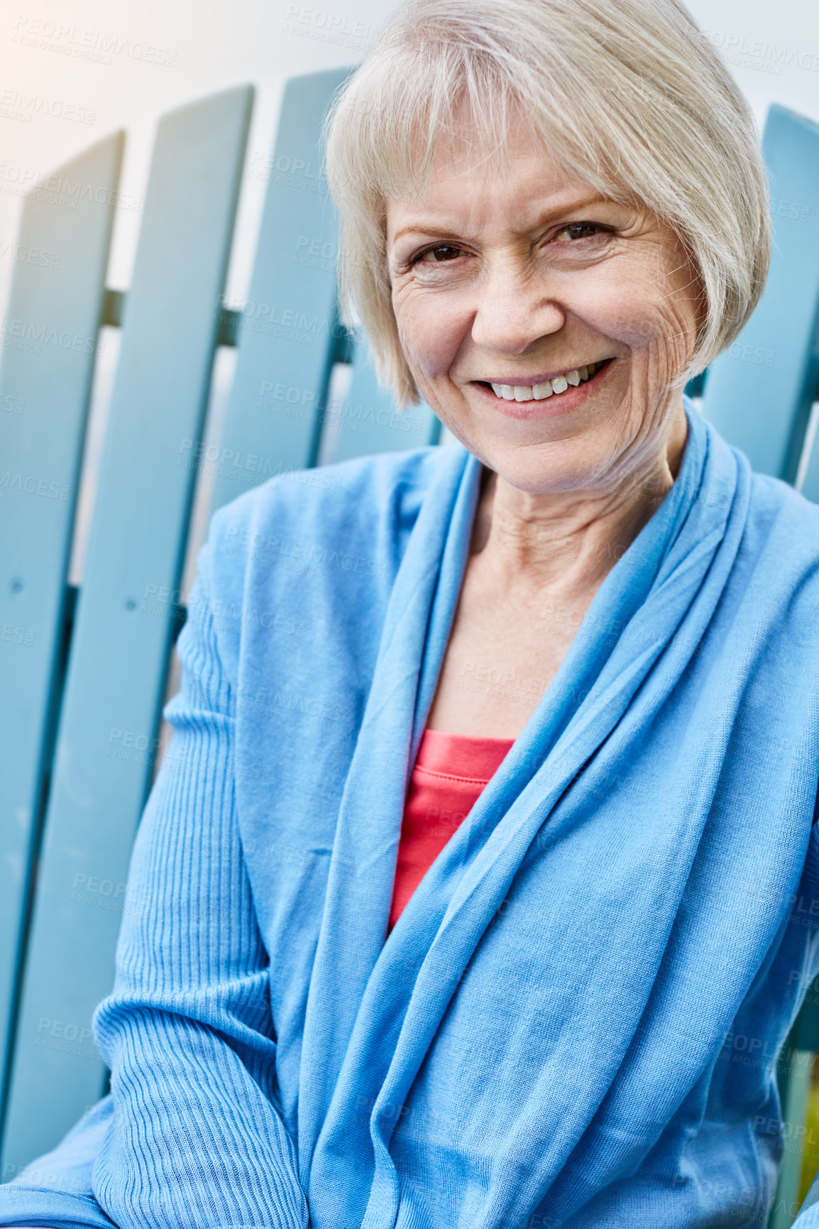 Buy stock photo Portrait of a happy senior woman relaxing on a chair outside