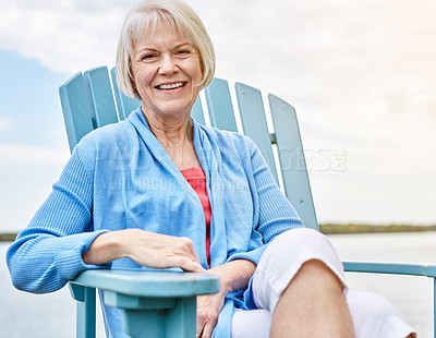 Buy stock photo Portrait of a happy senior woman relaxing on a chair outside